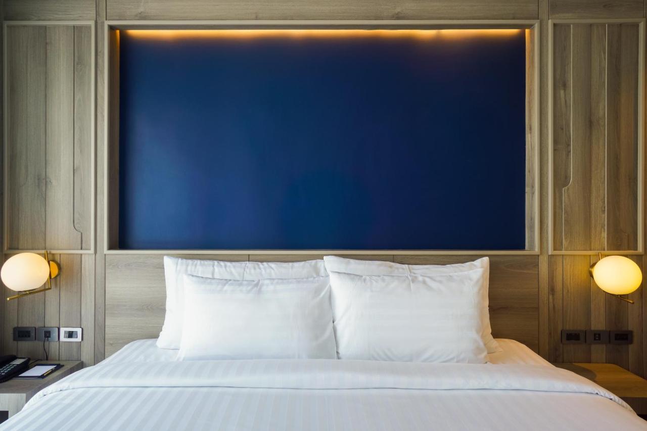 Seabed Grand Hotel Phuket - Sha Extra Plus Exteriör bild A bed with two pillows